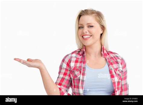 Blonde Woman Beaming While Placing Her Hand Palm Up Stock Photo Alamy