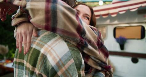 Over The Shoulder A Happy Brunette Girl In A Pink Checkered Shirt Hugs