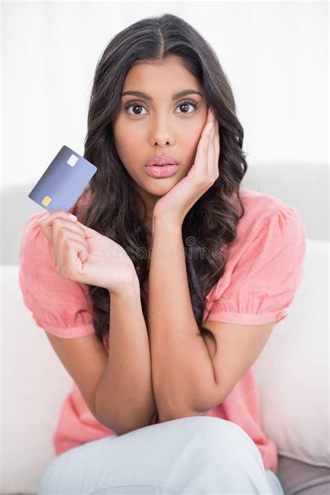 Shocked Cute Brunette Sitting On Couch Showing Credit Card Stock Image Image Of Cute Front