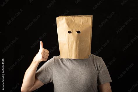 Man Wearing A Paper Bag Over His Head And Giving A Thumbs Up Stock