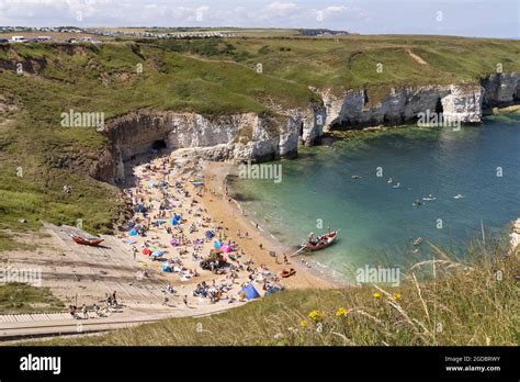 Yorkshire Beach People Sunbathing On A Hot Sunny Day In Summer