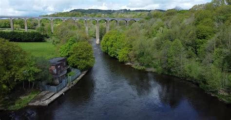 Aerial view Pontcysyllte aqueduct and River Dee canal narrow boat bride in Chirk Welsh valley ...