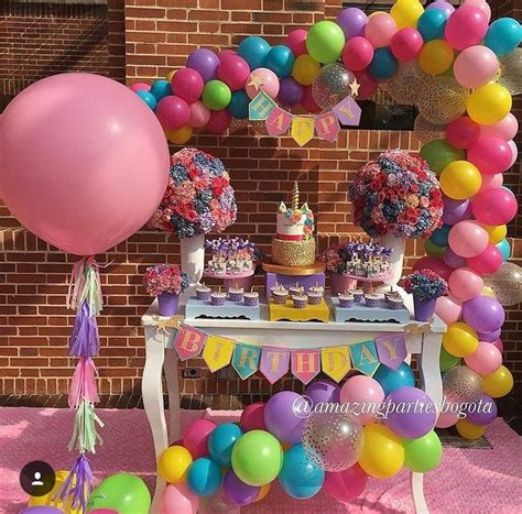 A Table Topped With Lots Of Balloons And Cake