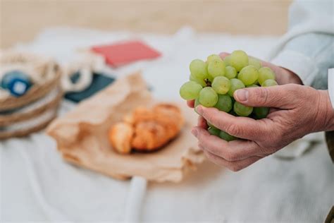 Primer Plano Una Mujer Adulta Sostiene Uvas En Sus Manos Contra El