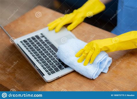 Hand Of Young Asian Woman Cleaning And Wipe Laptop Computer With