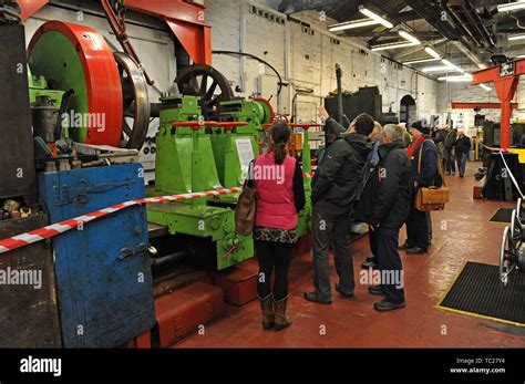 People Examining A Railway Wheel Lathe In The Machine Shop At