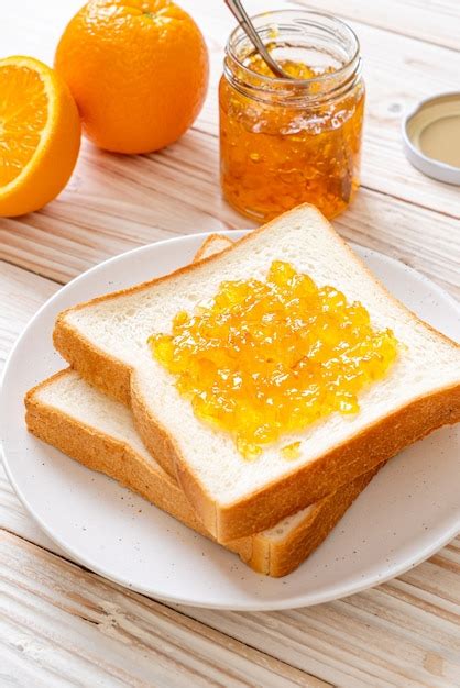 Premium Photo Slices Of Bread With Orange Jam