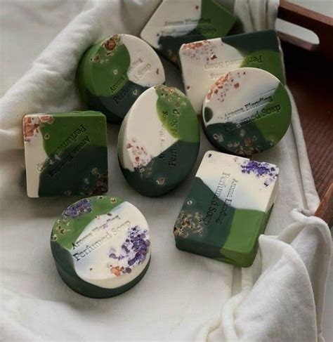 Several Soaps With Flowers On Them Sitting On A Towel