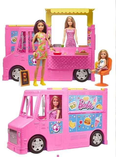 Two Barbie Dolls Standing In Front Of A Pink Food Truck