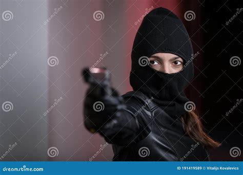 House Robbery By Woman In A Black Jacket And Black Mask Holding Black