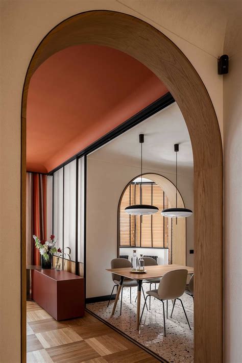 An Arched Doorway Leads Into A Dining Room