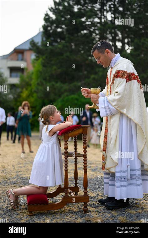 A Child Receiving The First Holy Communion Stock Photo Alamy