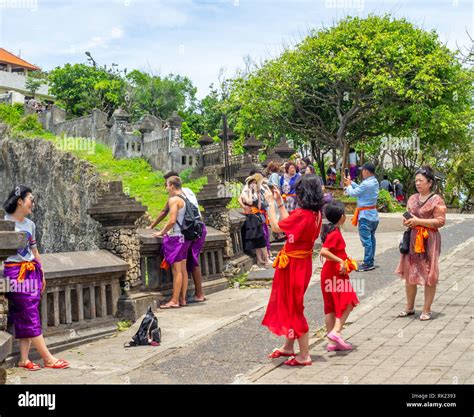 Chinese Tourists Wearing Purple Sarongs Visiting Uluwatu Temple Bali