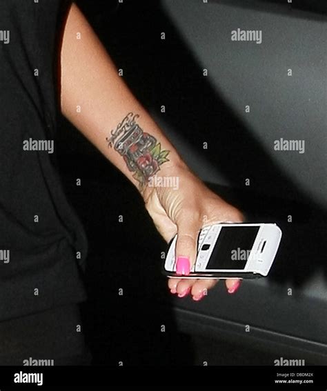 Katie Price showing off her new rose tattoo while enjoying a night on ...