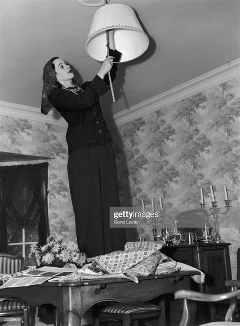 Austrian Born Actor Hedy Lamarr Standing On Her Dining Room Table And