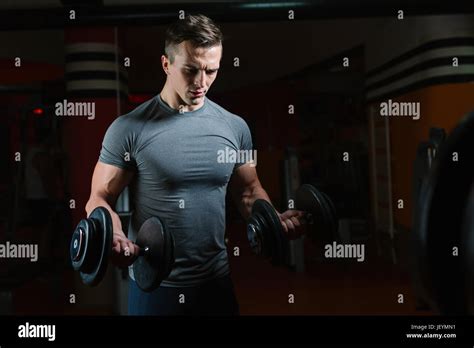 Closeup Portrait Of A Muscular Man Workout With Barbell At Gym