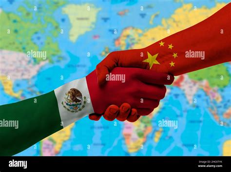 Handshake Between Mexico And China Flags Painted On Hands With