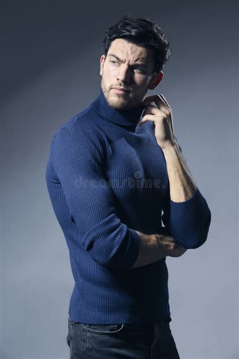 Portrait Of Caucasian Handsome Brunet Man Posing In Blue Turtleneck