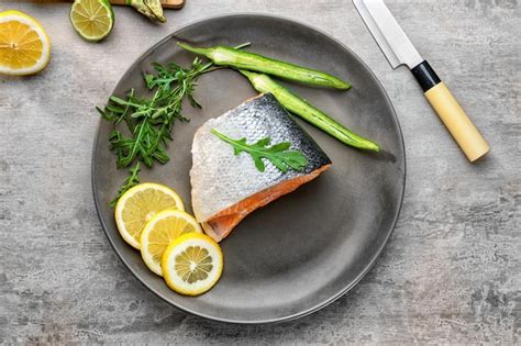 Premium Photo Fresh Salmon Fillet With Arugula And Lemon On Plate