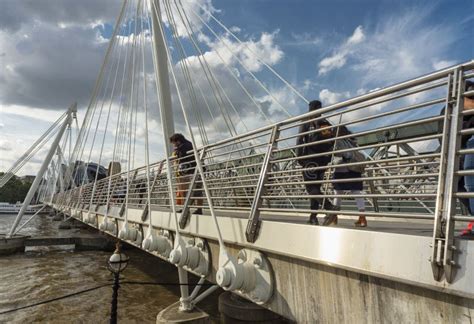 Pedestrians Crossing The Queen`s Golden Jubilee Footbridges In The