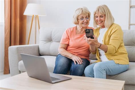 Premium Photo Two Happy Senior Women Using Laptop Computer And Smart