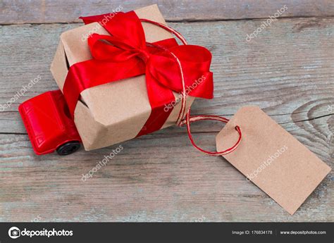 Red Toy Car Delivering Ts Box With Tag With Empty Space For Stock