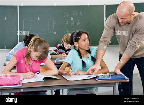 A Teacher Working With Students In A Classroom Stock Photo Alamy