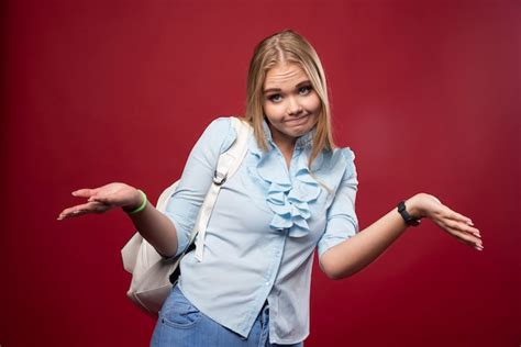 Étudiante Blonde Avec Sac à Dos Semble Indifférente Photo Gratuite
