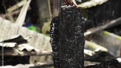 Black Burnt Log With Rusty Bent Nails Of A House Burned By Fire Wood