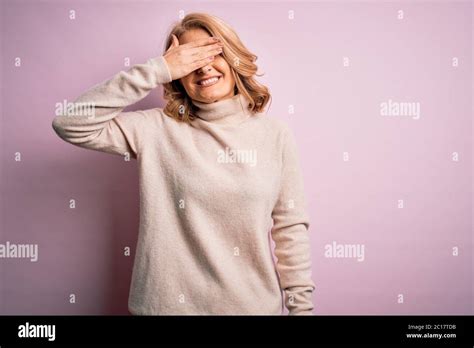 Middle Age Beautiful Blonde Woman Wearing Casual Turtleneck Sweater Over Pink Background Smiling