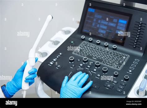 Gynecologist Adjusts Ultrasound Device For Examining Pelvic Organs