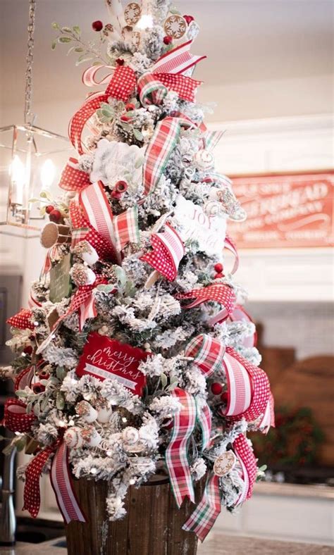 A Christmas Tree With Red White And Green Ribbons