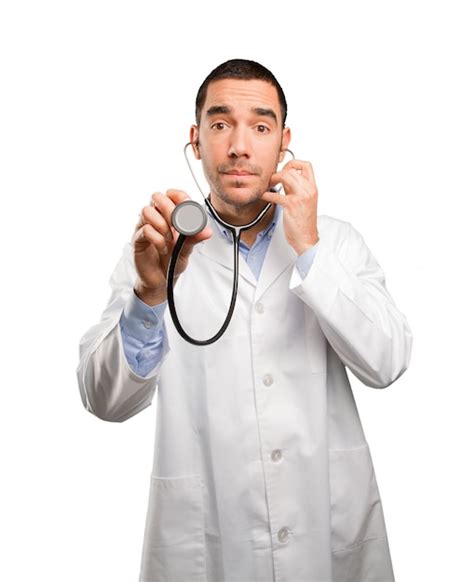 Premium Photo | Thoughtful young doctor using a stethoscope