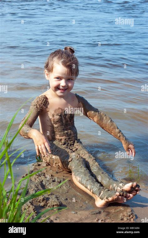 Naughty Baby Girl In The Mud On The River Stock Photo Alamy