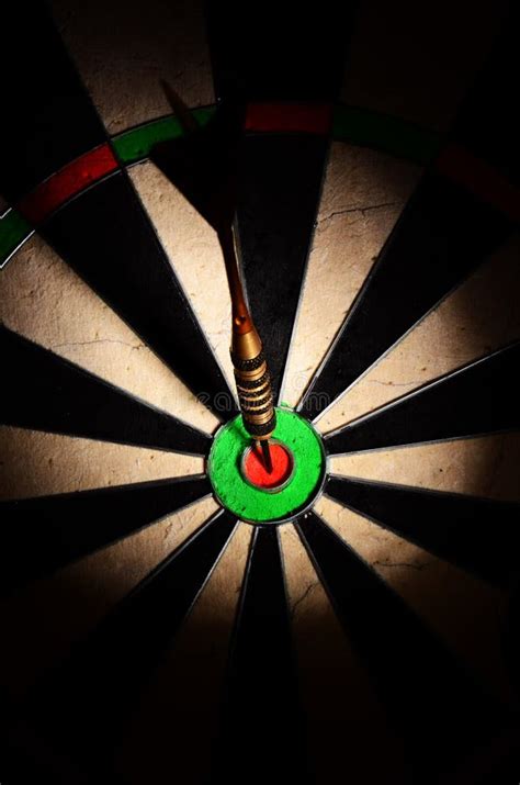 Dart Arrow Hitting In The Target Center Of Dartboard Stock Image