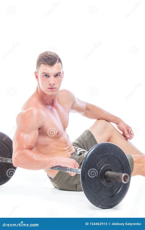 Muscular Man Working Out In Studio Doing Exercises With Barbell At