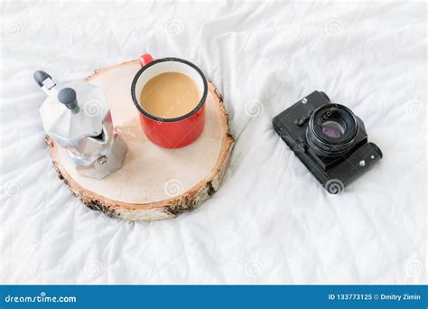 Coffee Mug With Coffee Maker On Tray With Vintage Camera On Bed Stock