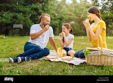 Happy lovely family eating sandwiches on picnic Stock Photo - Alamy