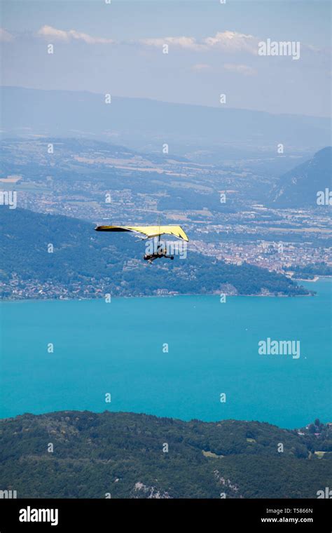 Hang Glider Instructor Flying In Hang Glider With Customer Over Annecy