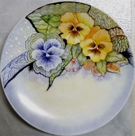 A White Plate With Yellow And Blue Flowers On It