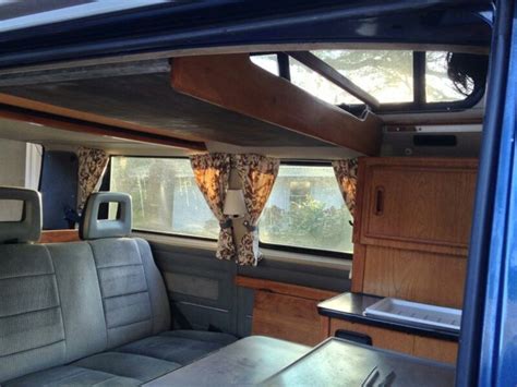 VW Hi Top Camper Van With Wood Paneling And Curtains