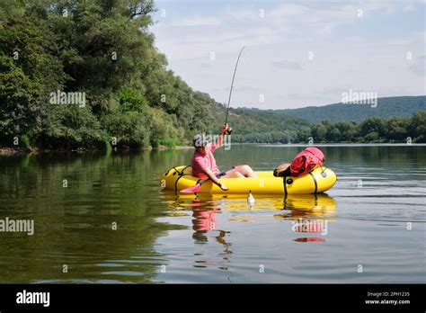 Fisherman Caught A Fish From Rubber Boat Mature Man Fishing From The