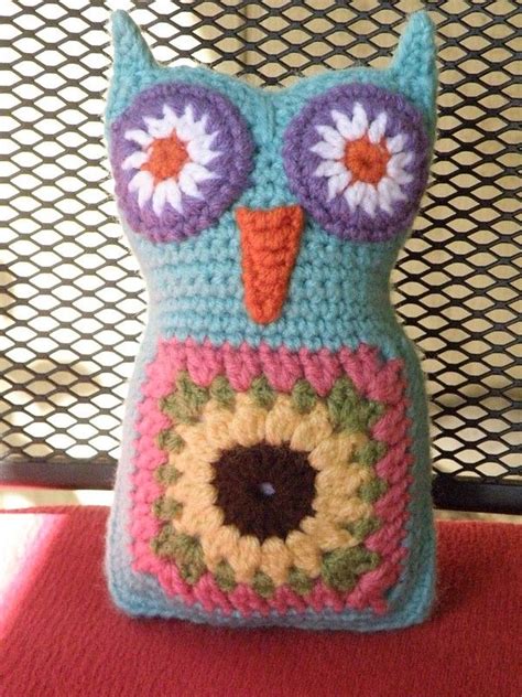 A Crocheted Owl Pillow Sitting On Top Of A Table