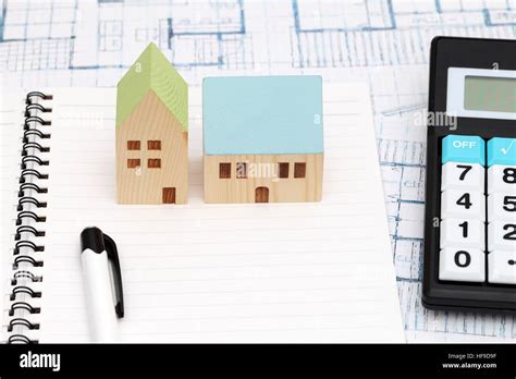 Miniature model of house and blueprints, construction plan Stock Photo ...