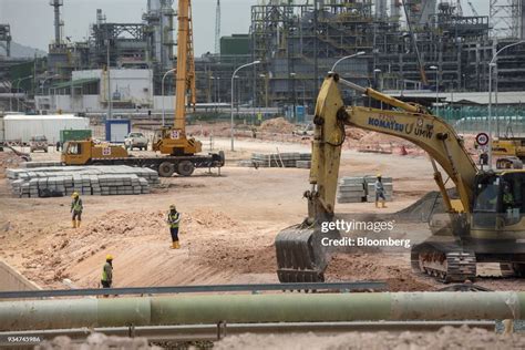 An Excavator Operates At The Under Construction Petronas Nasional