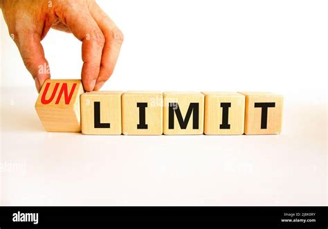 Limit Or Unlimit Symbol Businessman Turns Wooden Cubes And Changes The