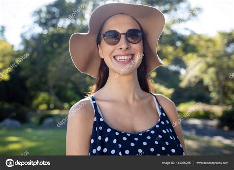 Woman Wearing Sunglasses And Hat Stock Photo By Wavebreakmedia