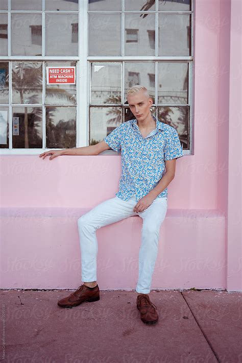 Blond Gay Man Sitting On A Pink Bench Del Colaborador De Stocksy Mauro Grigollo Stocksy