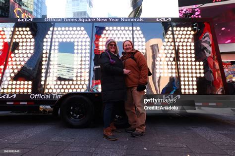 People pose with the New Year's Eve '2024' Numerals, to be lit up at... News Photo - Getty Images