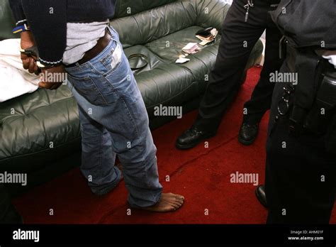 A Man Is Arrested And Handcuffed By Police During A Police Raid On A